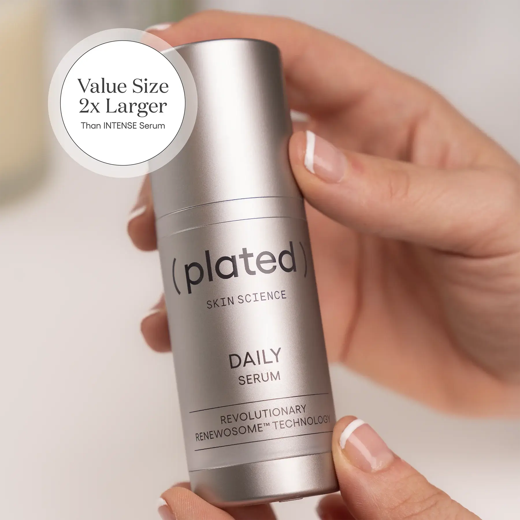 Hand holding a ( plated )® Skin Science 30 mL DAILY Refill Serum bottle labeled 'plated' with text about size and technology.