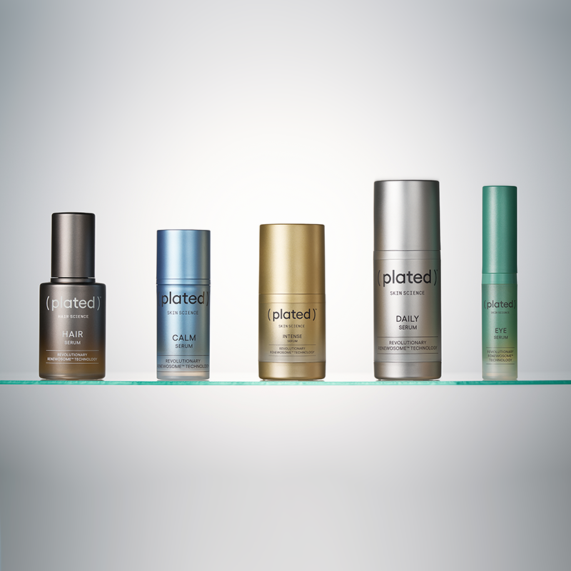 Five ( plated ) Serum skincare products on a glass shelf with a grey background