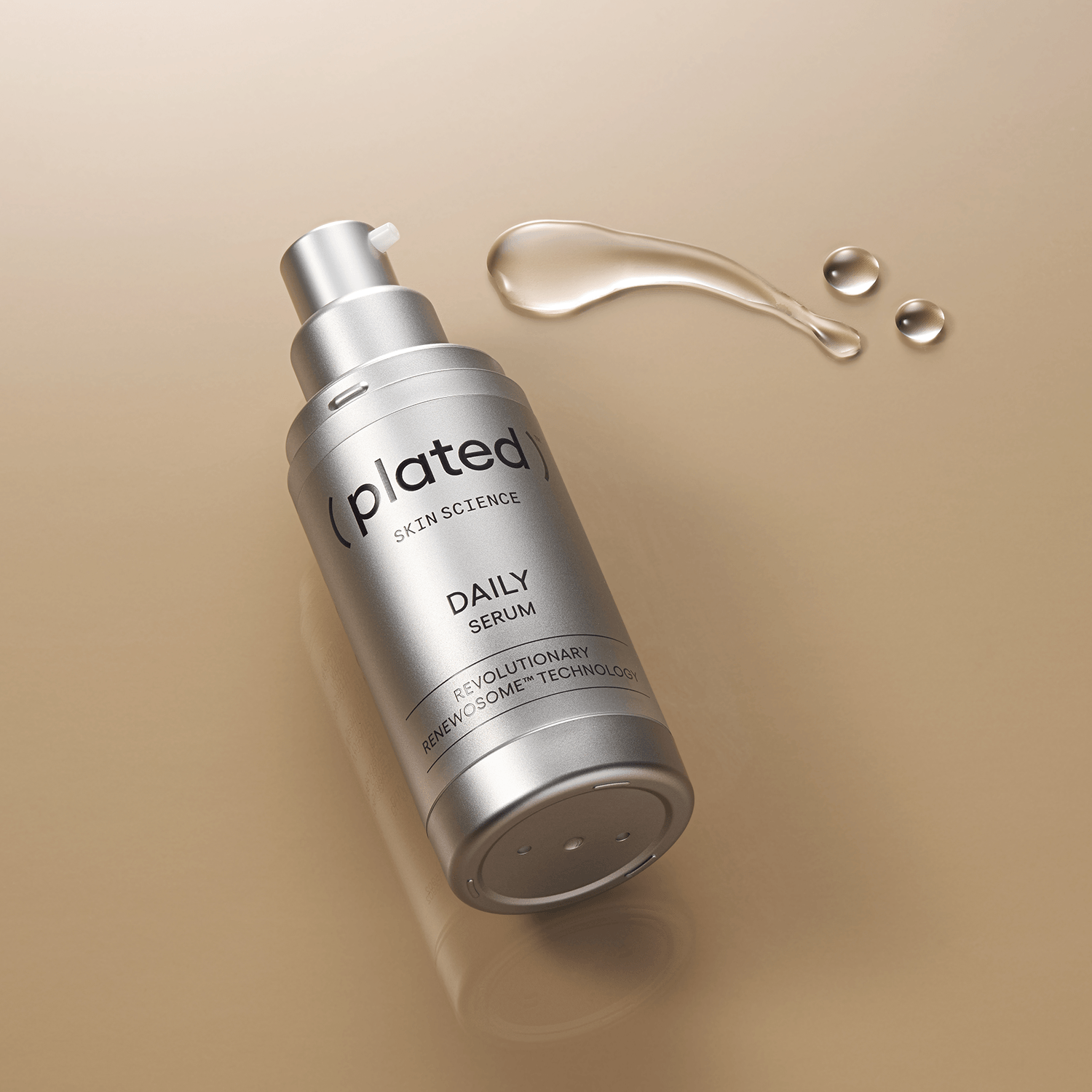 Silver ( plated ) DAILY Serum bottle on a beige background with droplets of serum.