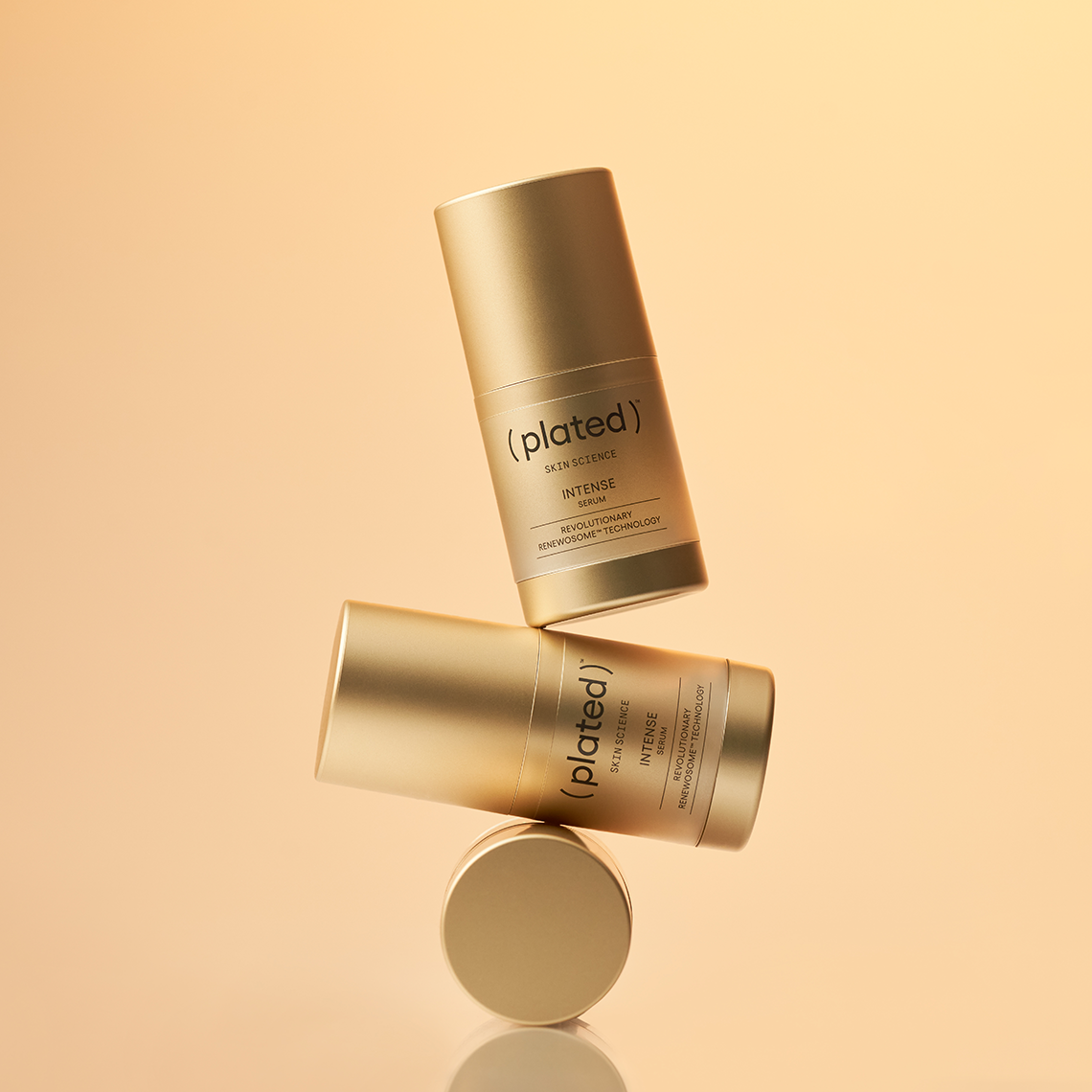 Three bottles of the INTENSE Serum 15 mL stocked on top of each other on a beige background.