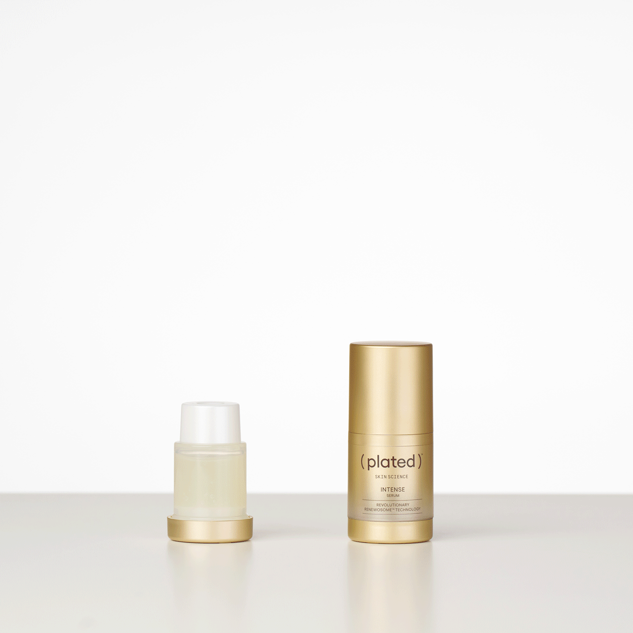 ( plated ) Skin Science INTENSE Serum bottle and refill cartridge on a white background - Step 1 of Refill Sequence
