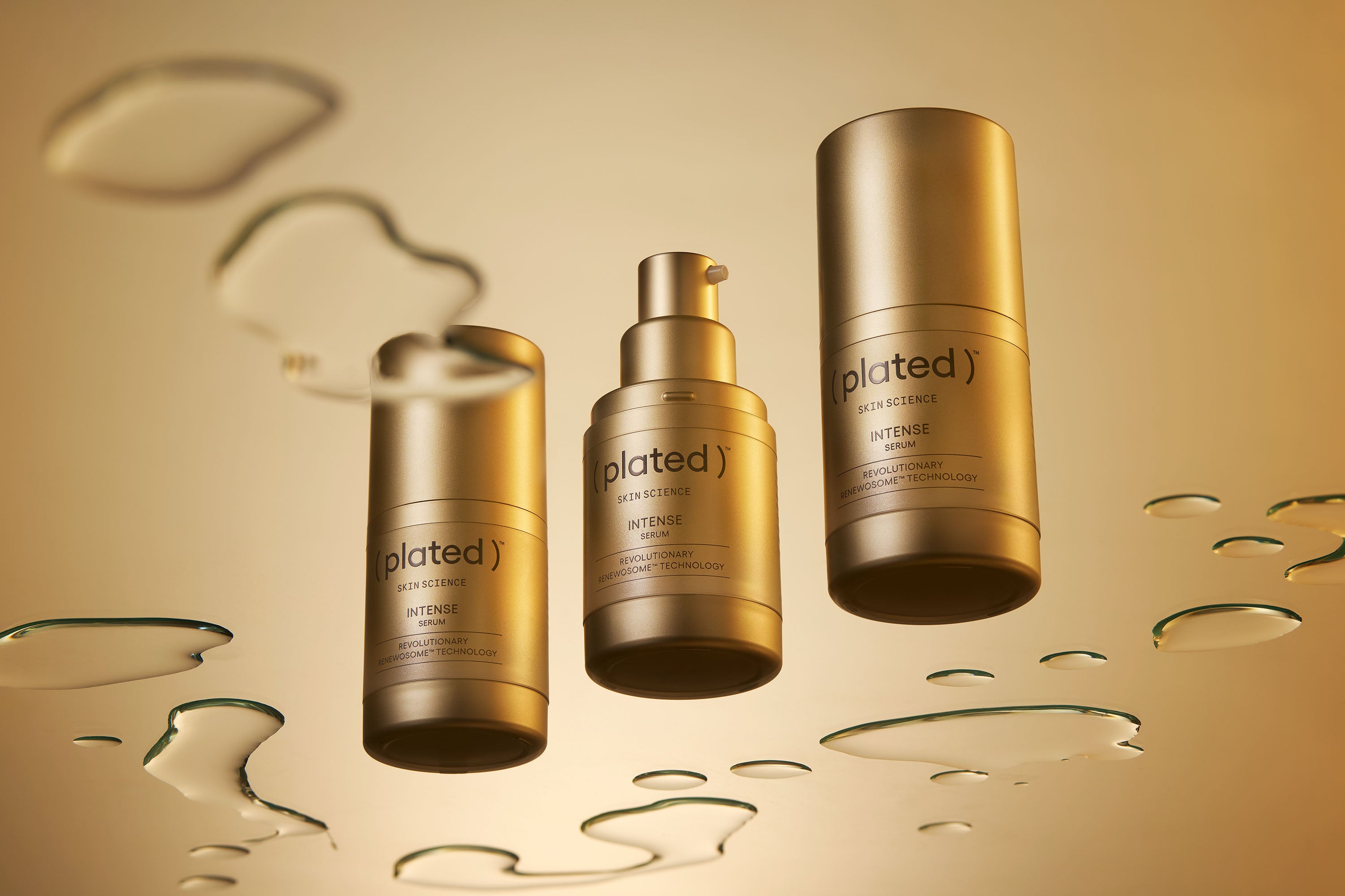 Three INTENSE Serum 15 mL bottles on gold background with serum droplets.